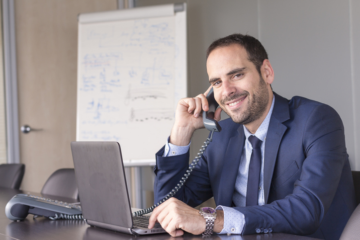 Insurance agent on a call in an office